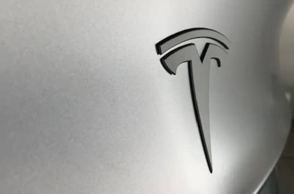 Tesla logo on a silver background